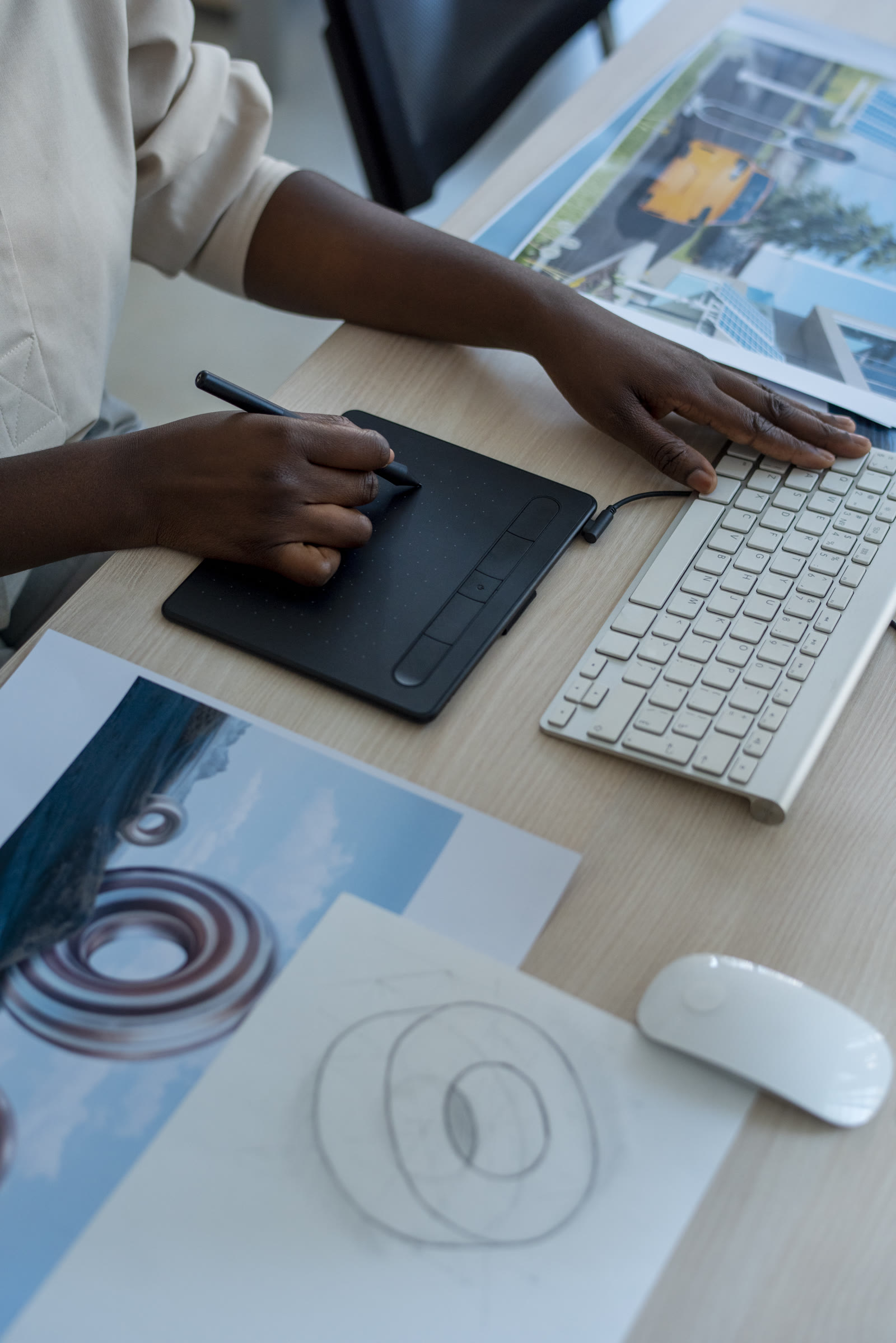 Designer sketching on a tablet at a desk